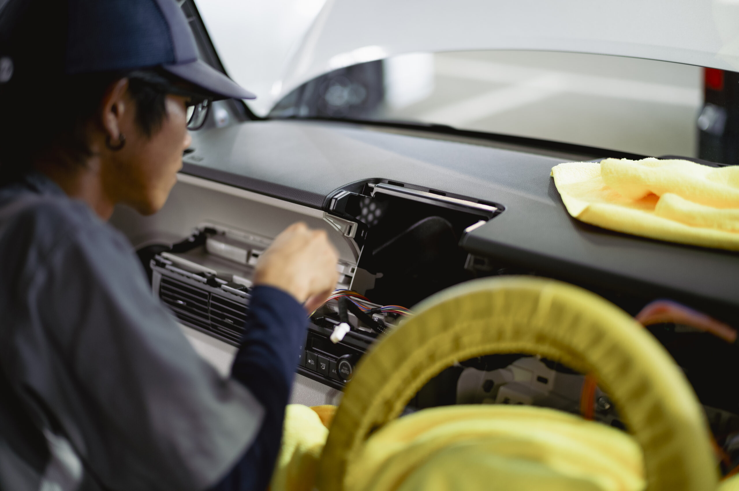 カーナビなどの車内用品を取り付けるスタッフ